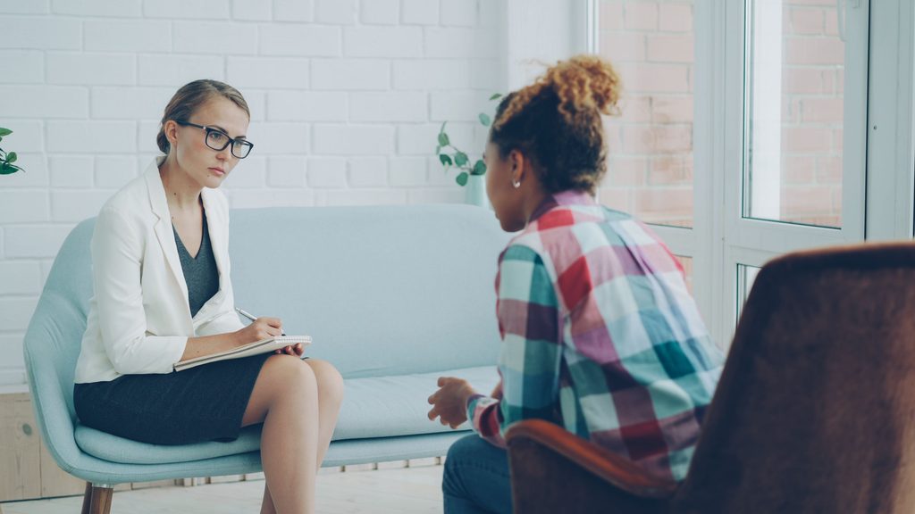 Therapist and patient comparing ERP therapy and talk therapy for OCD