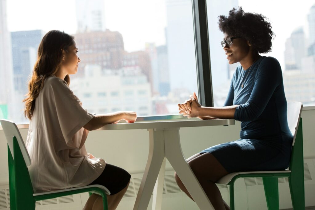 Patient and provider talking at a table during a first psychiatric evaluation in Burbank
